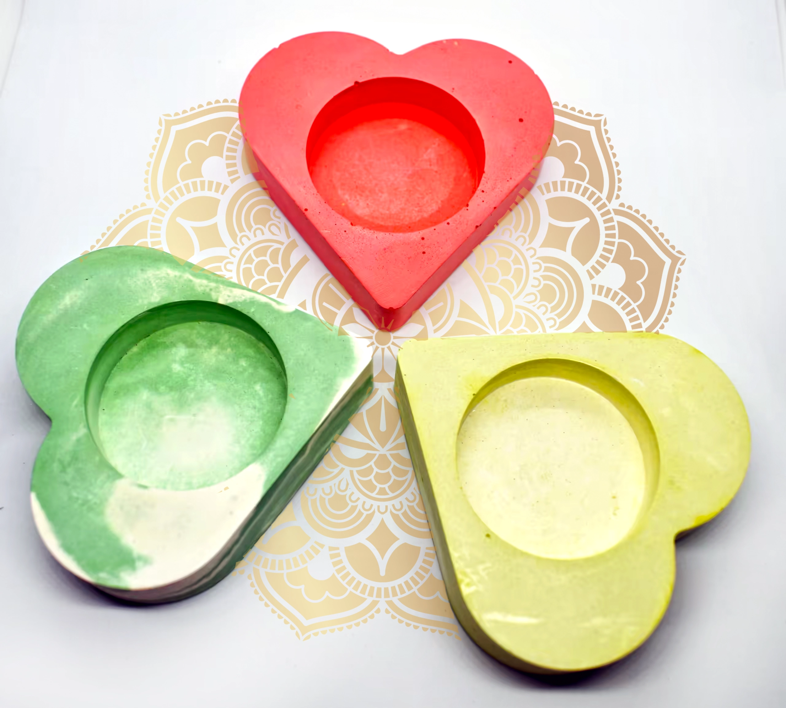 Red heart-shaped object with layered cutouts centered on a decorative beige and white patterned background, surrounded by green and yellow hearts.